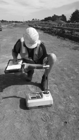 A photo of a technician looking at a density gauge